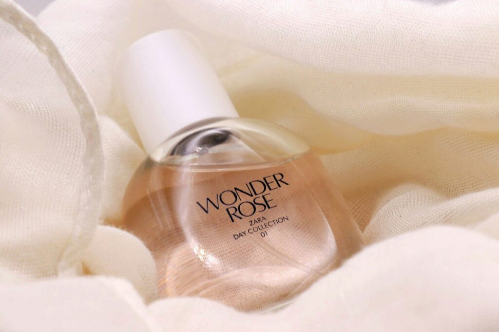 a bottle of perfume sitting on top of a white cloth